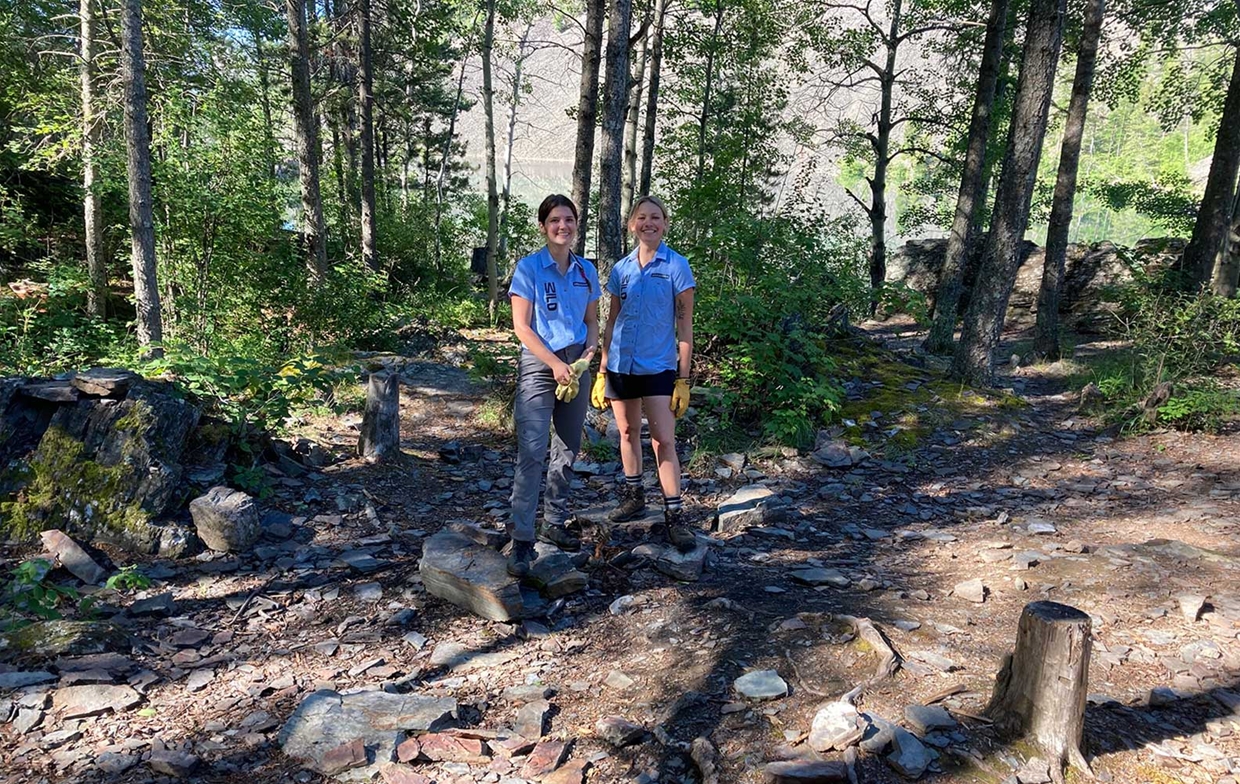 Ambassadors cleaning garbage and dismantling firepits