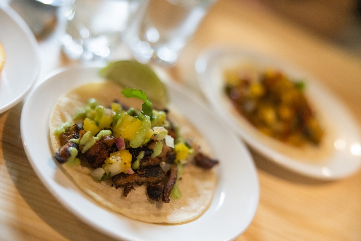 Ingredients include corn roasted in house, freshly made pico de gallo and hand pulled pork